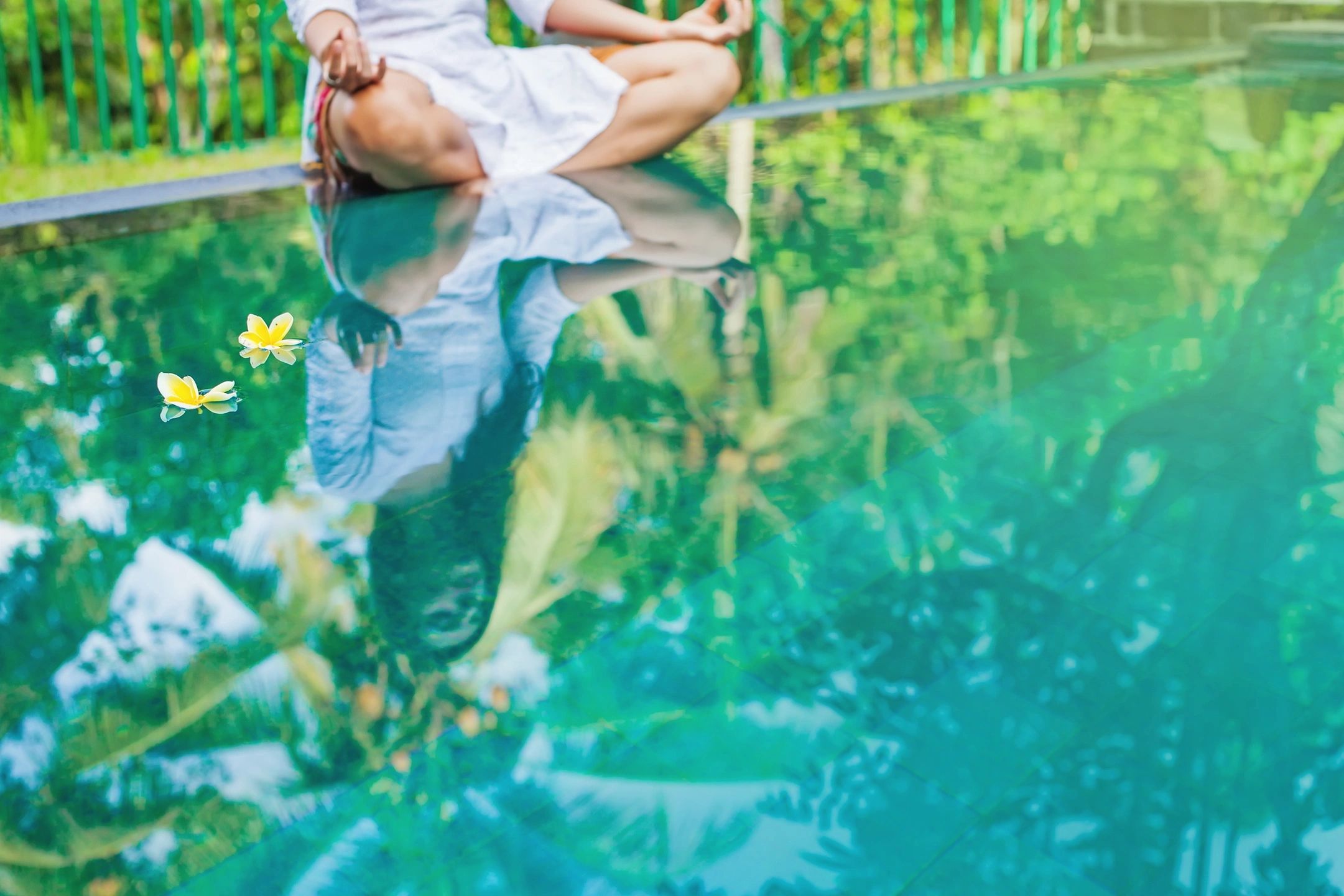 Peaceful reflection on a wooden deck by a pond